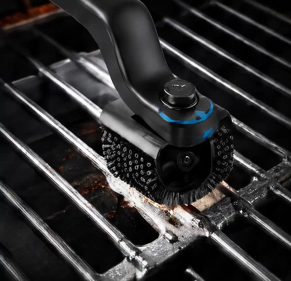 BBQ cleaning brush reaching between grill grates